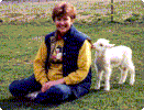 A newborn lamb gives Sarah a kiss.