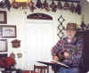 Bob plays the guitar in the kitchen.