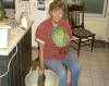 Sarah bruises the shredded cabbage with a heavy board.