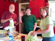 The kitchen gang turns the cabbages into shredded cabbage.