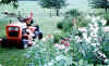 The tractor hauls flowers and vegetables to the house. Note the sheep in the background.