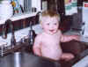 Grandson Michael takes a bath in the kitchen sink.