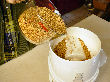 Loading wheat berries in the top hopper of the Nutrimill grain mill.